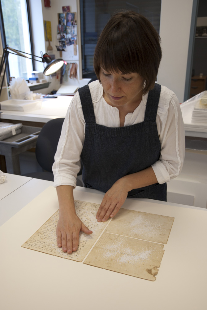 Conservator surface cleans historic document