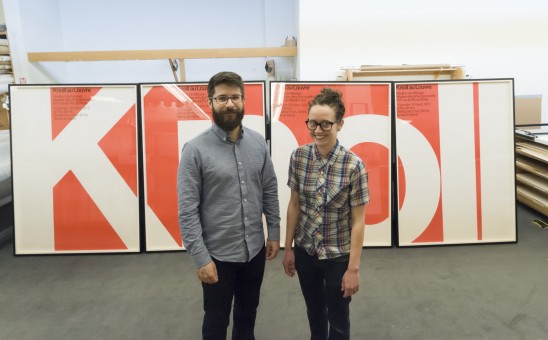Conservation staff pose in front of framed Knoll posters