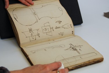 Surface cleaning a book with violin illustrations