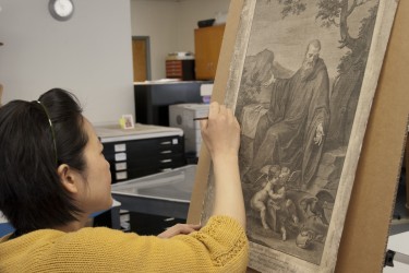 Conservator inpaints an etching