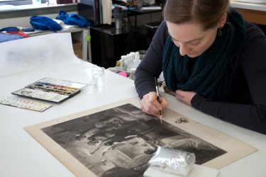 Conservator inpaints an engraving