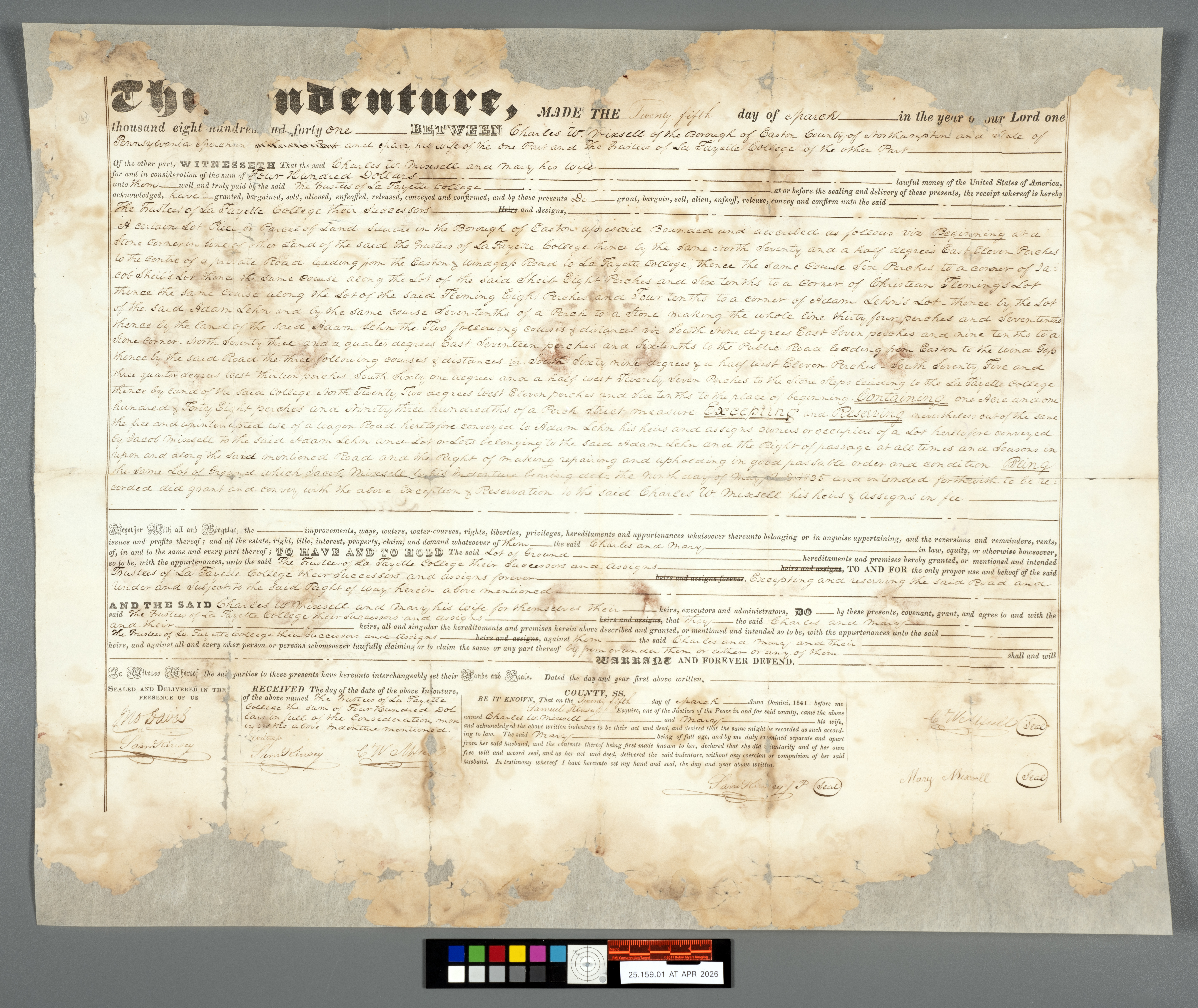 * High-resolution record shot of a 1841 handwritten land indenture document after conservation treatment, laid flat on a neutral background with a color calibration target at the bottom.