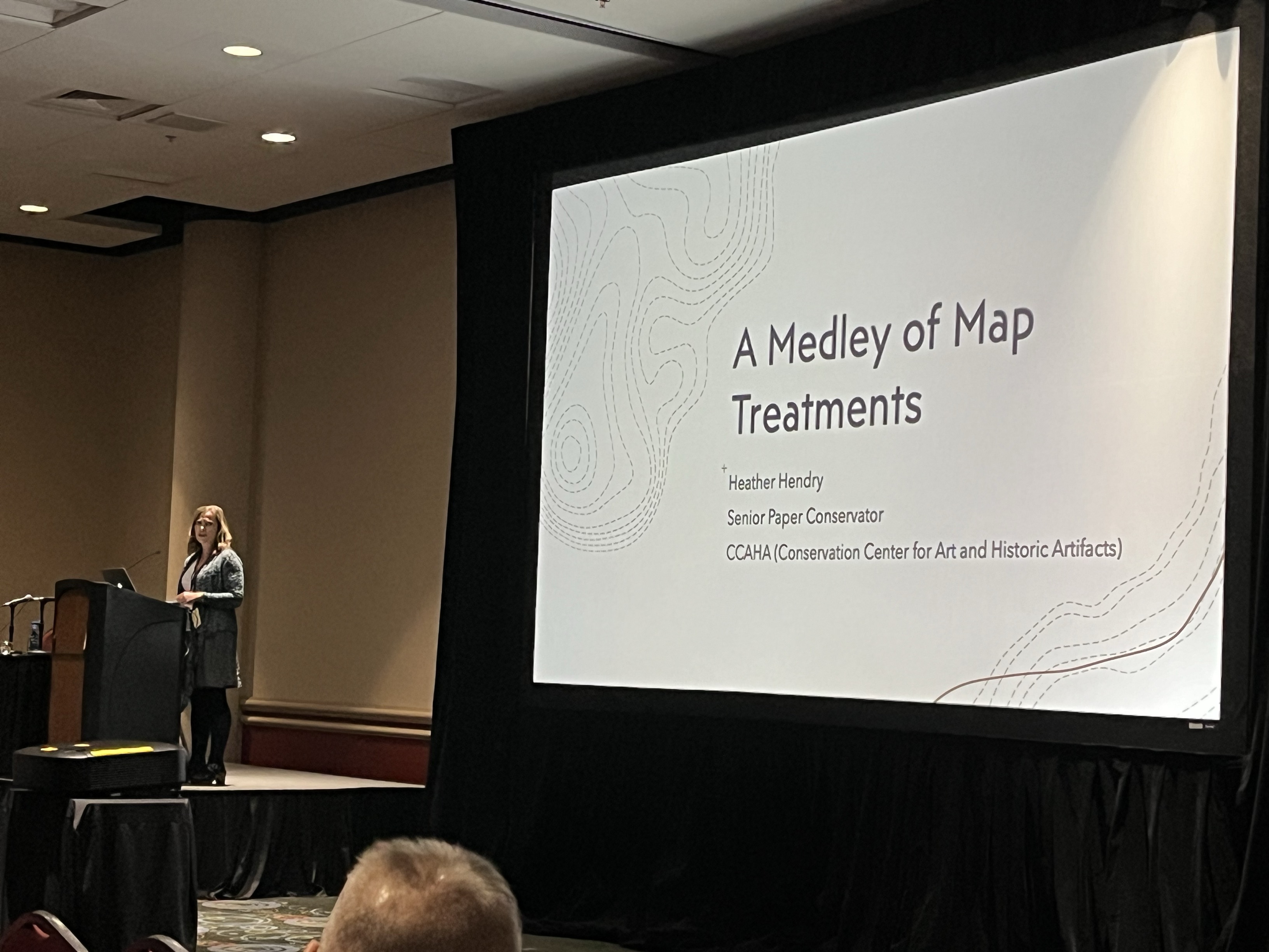 Heather Hendry, pictured on stage, presents at AIC 2024 in Salt Lake City. 
