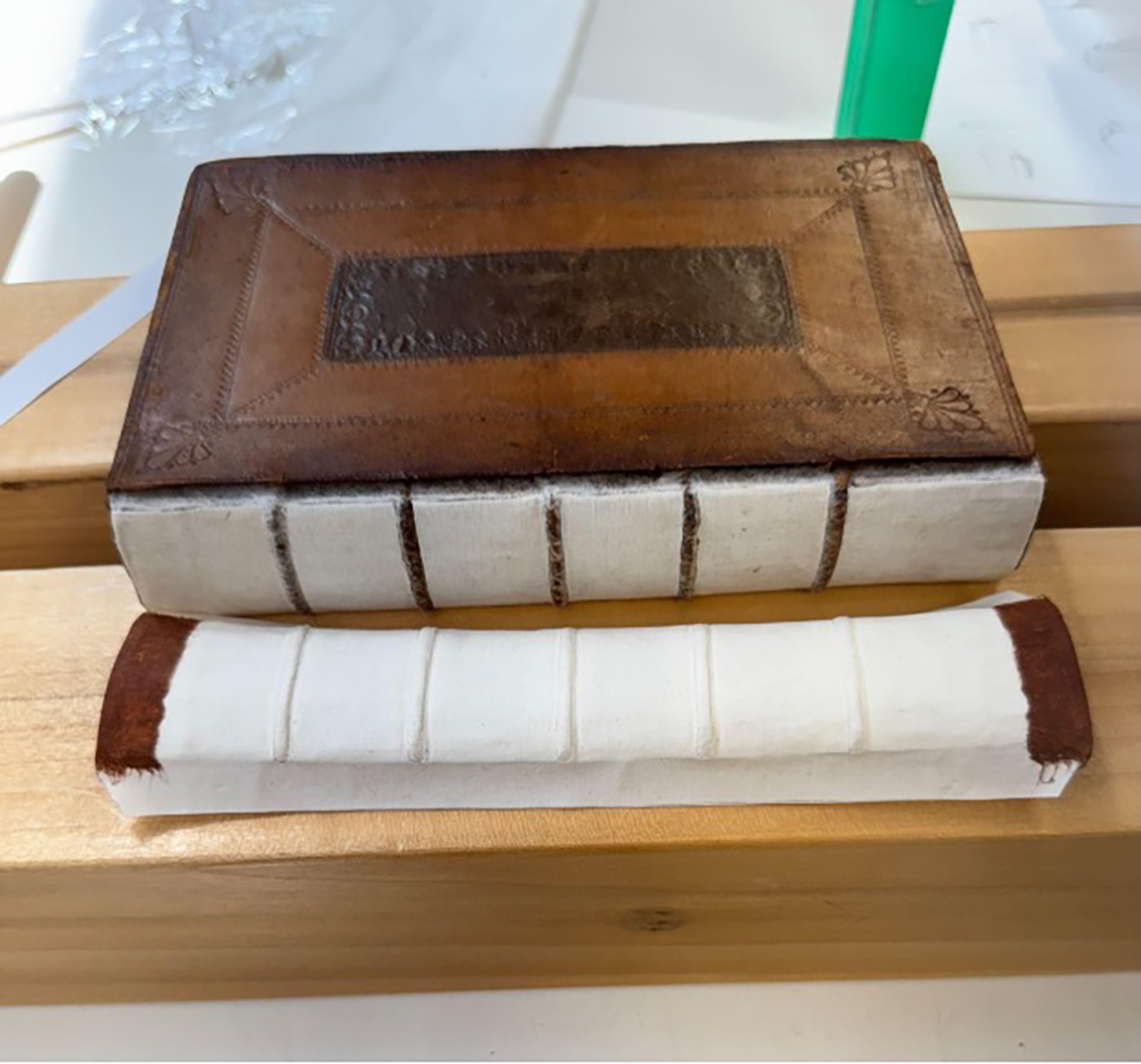 A book lying closed, with head and tail panels edges wrapped in toned kozo.