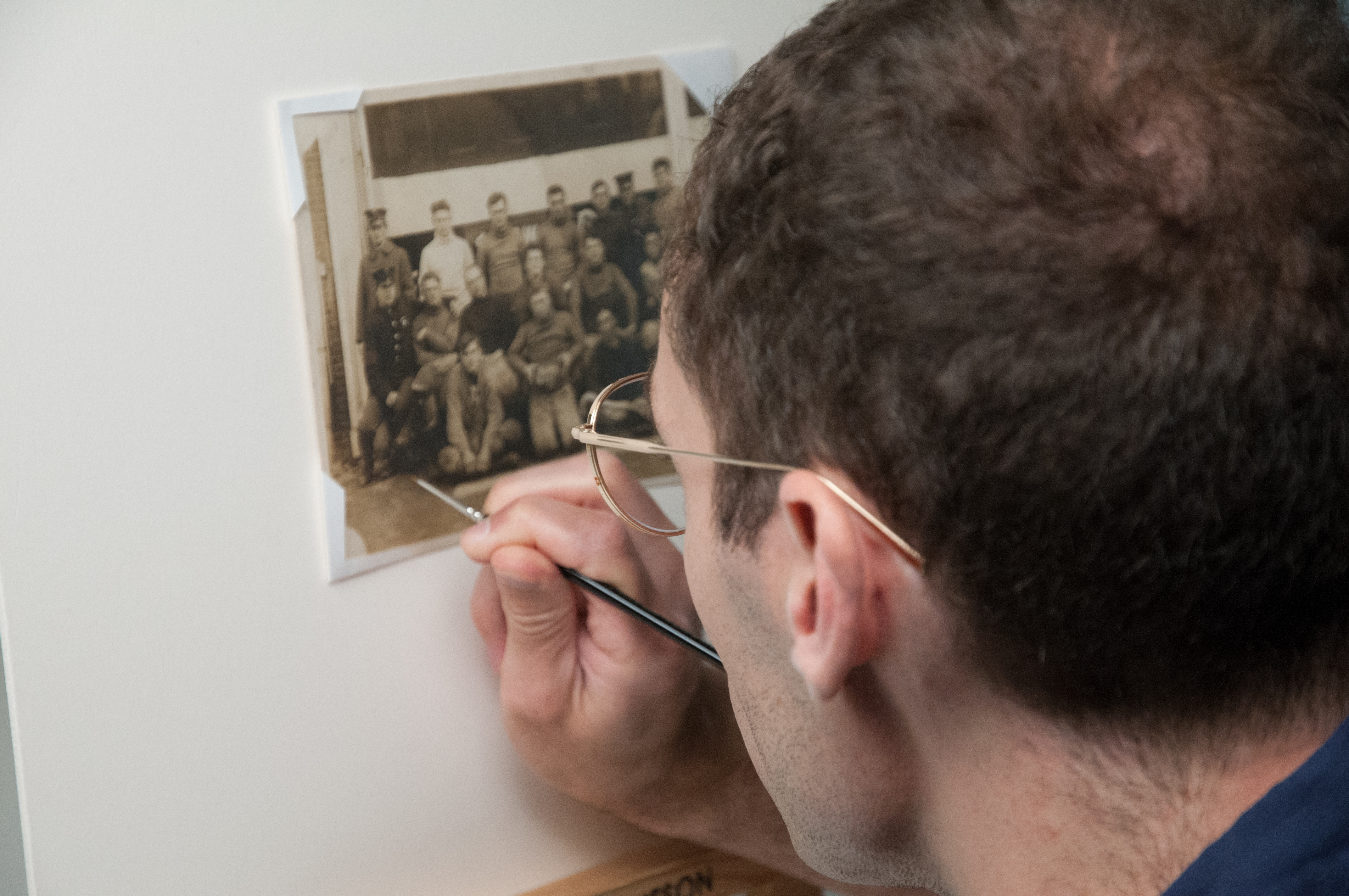 Photograp Conservator Zach Long uses watercolors to inpaint areas of the photograph