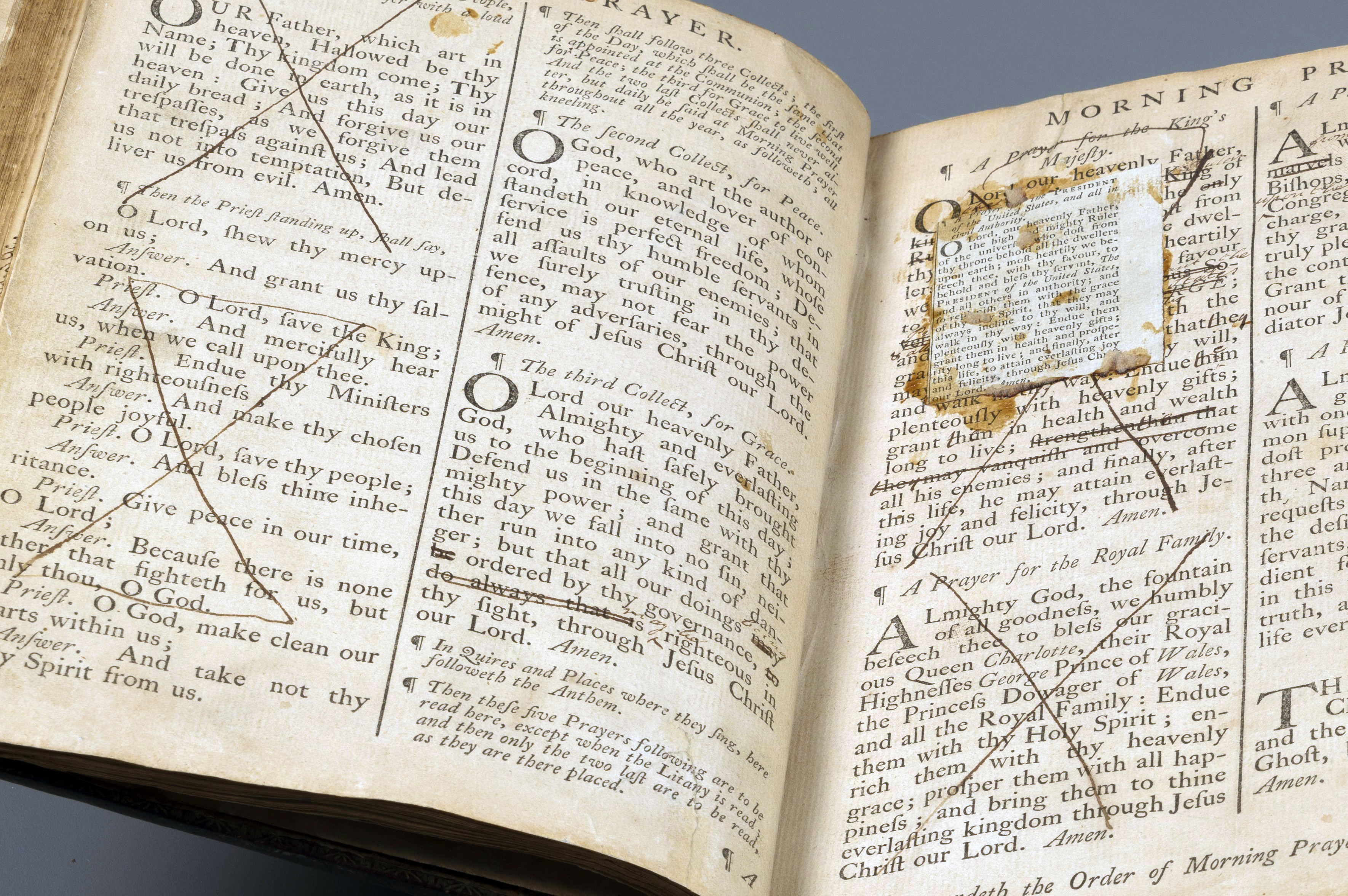 1768 prayer book with a large ink "X" through a prayer for the King and a paper slip referencing the "United States" pasted over the original text.