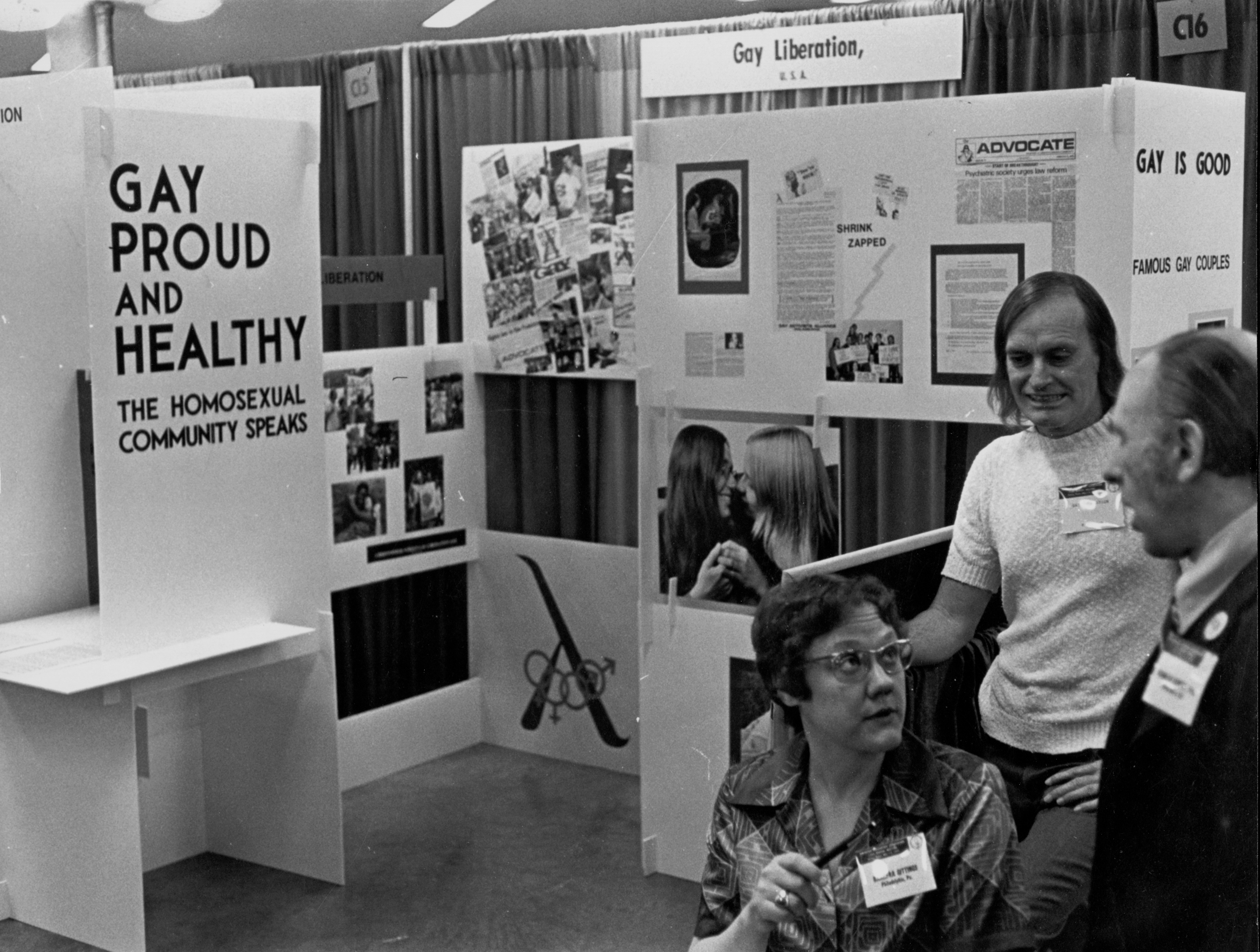 Archival 1970s photograph of Barbara Gittings and others with conference displays