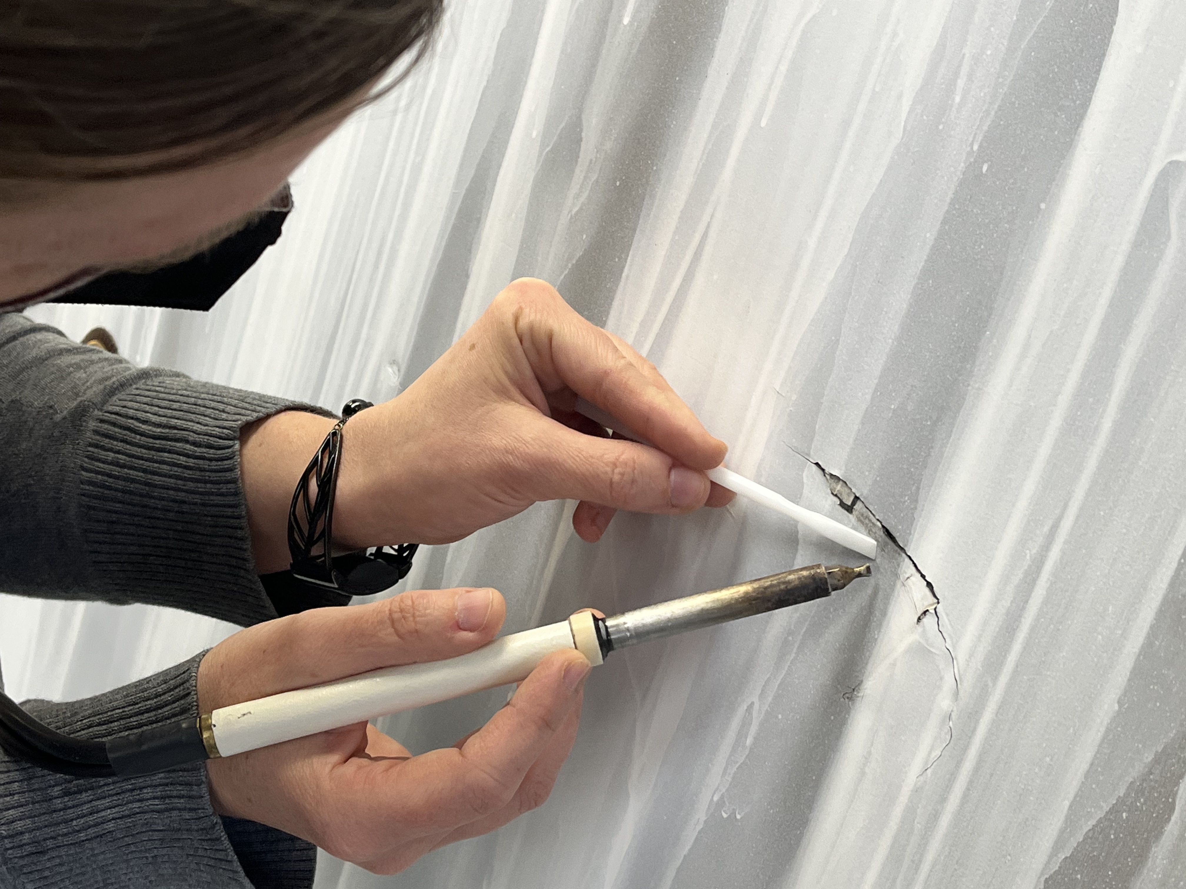 Heather Hendry repairs damage to one of Shofuso's screen doors.