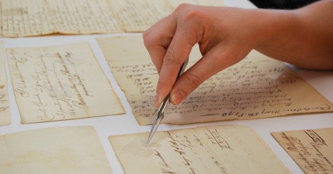 A hand spot-treating a paper document