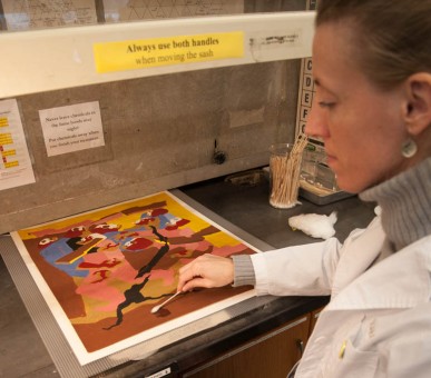 Conservator rolling a solvent swab