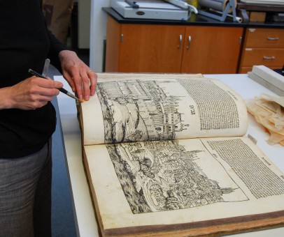 Conservator surface cleans manuscript pages