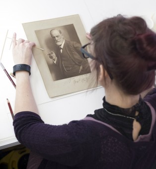 Conservator removes stain from photograph of Freud