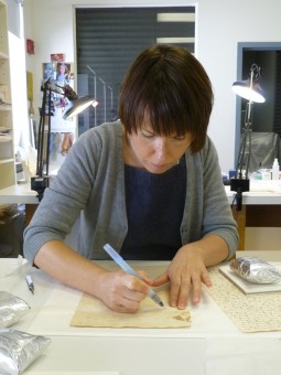 Conservator mends a tear in historic document