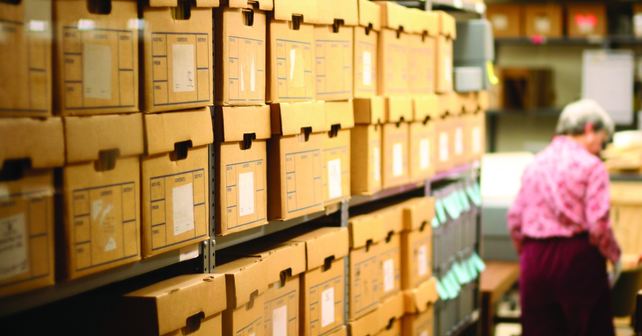 Shelves of archival boxes in a storage space