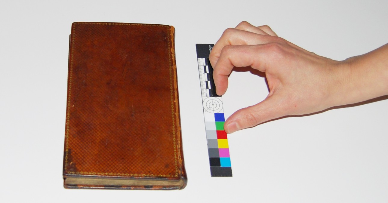 Hand with scale and first American edition of Emma