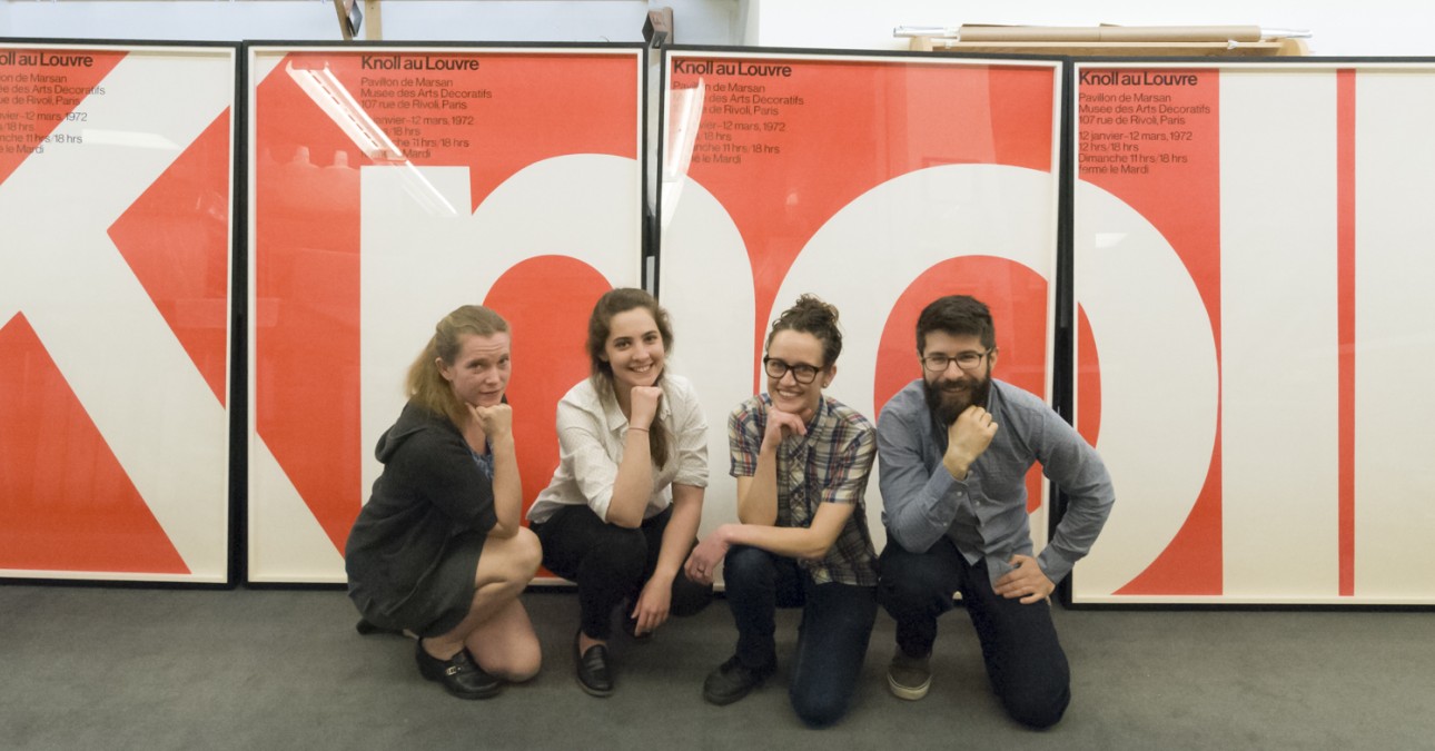 Conservation staff pose in front of framed Knoll posters