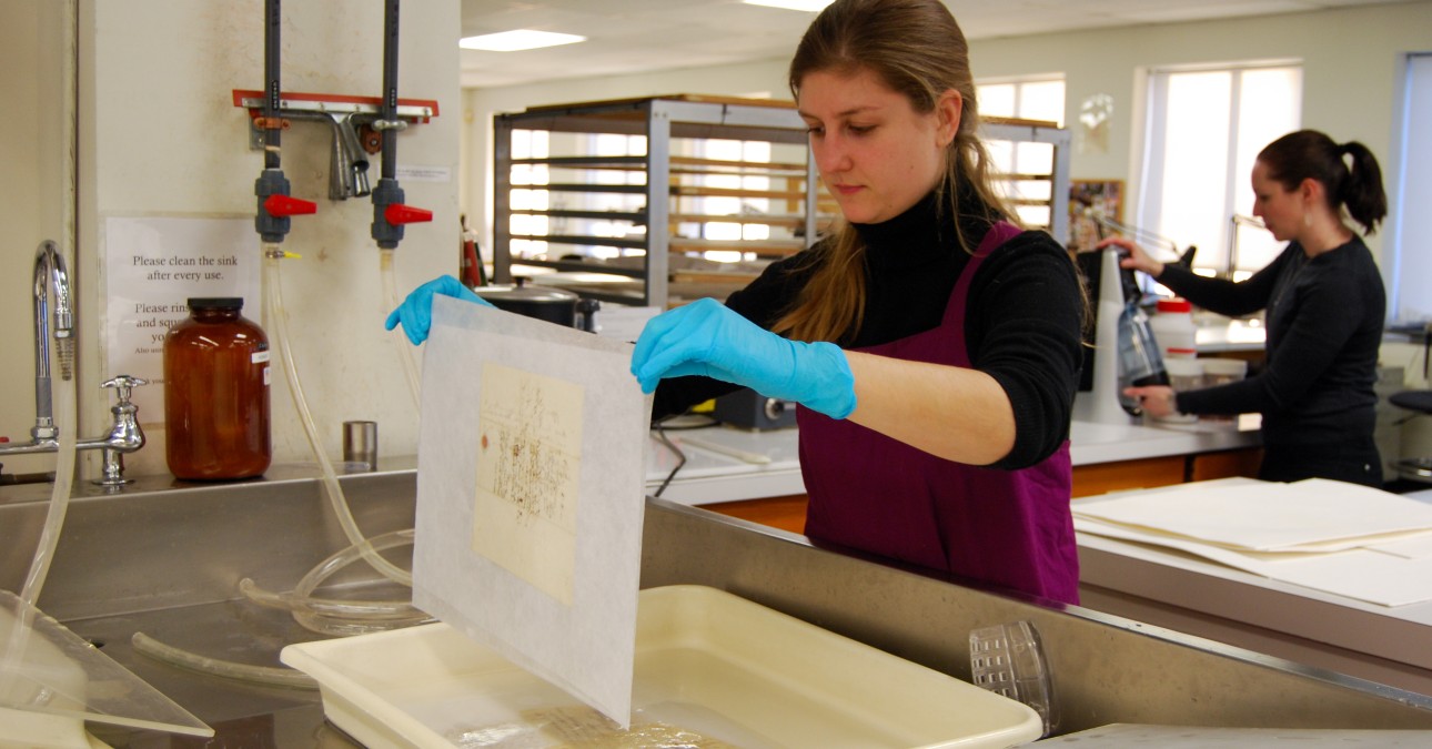 Conservator lifts document from bath