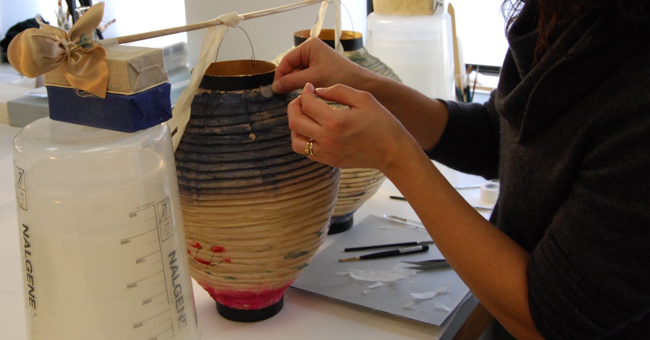 Conservator works on paper lanterns