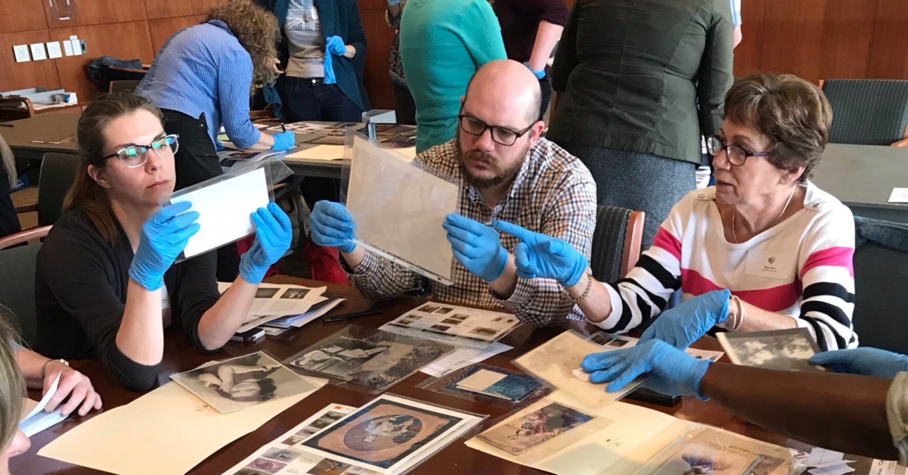 Workshop participants examine photographs
