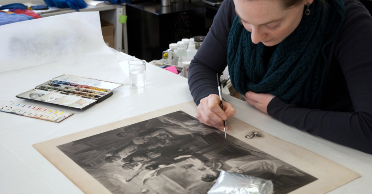 Conservator inpaints an engraving