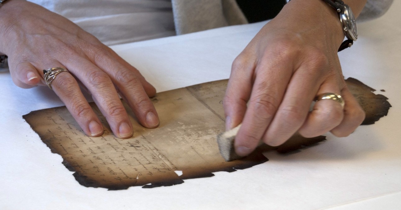 Surface cleaning a burned document