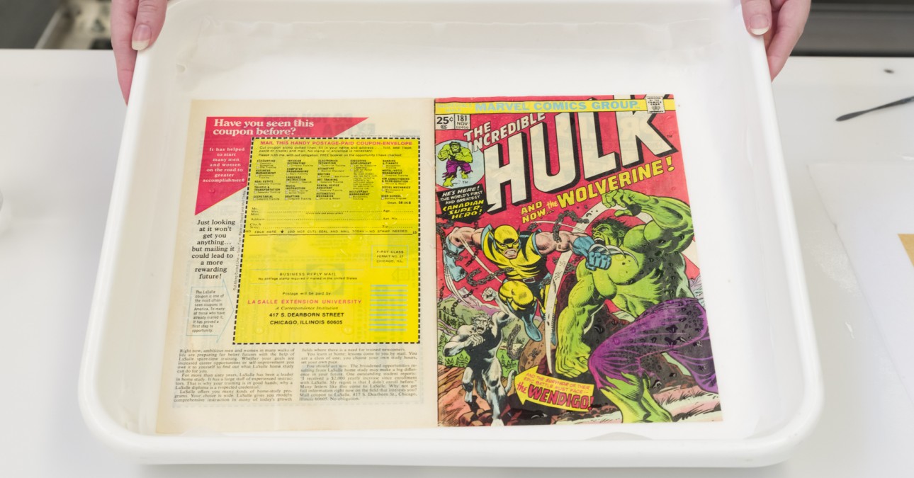 Paper Conservator Chloe Houseman displays a rare copy of The Incredible Hulk #181 before