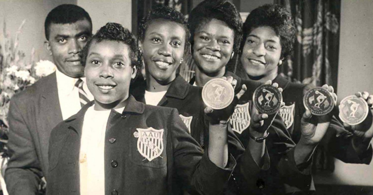 Tigerbelle track team and Coach Edward S. Temple with medals from a 1958 meet in Moscow, courtesy of the University of Tennessee, Knoxville, Special Collections