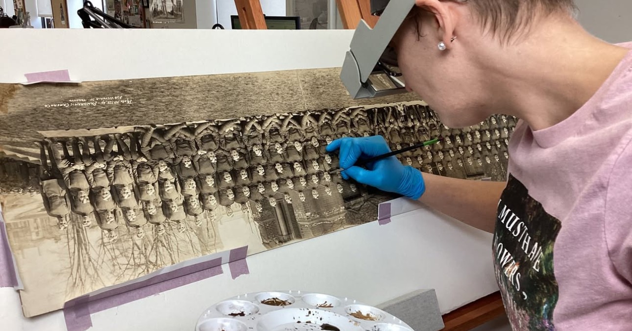 Ivy working on a WWI-era panoramic photo, from the collection of a local client, depicting the School of Aeronautics of the Royal Air Force and the Royal Flying Corps in Canada.
