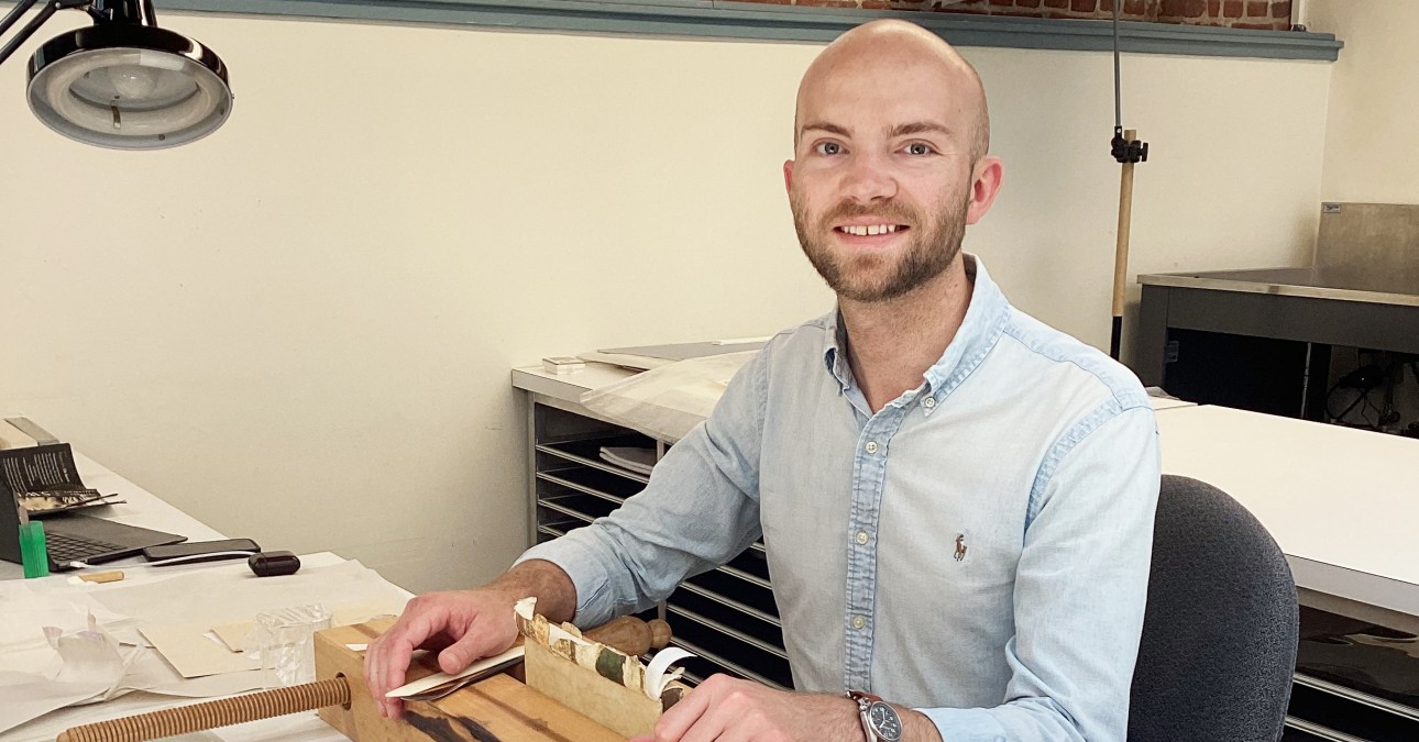 CCAHA Summer 2025 Intern, Luke Kelly. He is sitting at a desk and wearing a blue shirt.