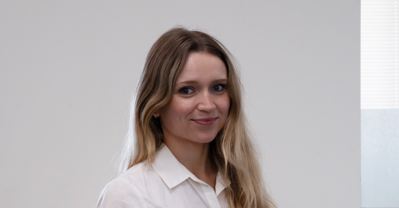 A photo of Lauren Stroupe, wearing a white shirt, in front of a white background.