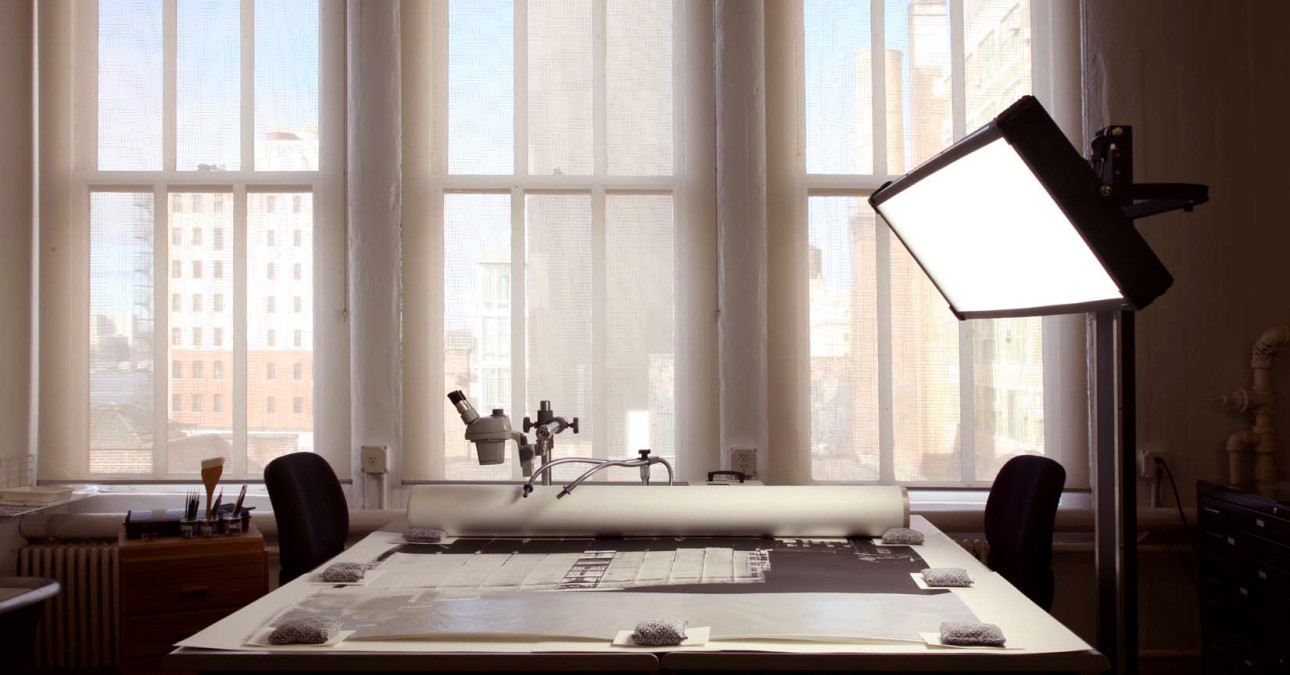 An image of the CCAHA satellite studio in New York City, featuring a table with an object and overhead light.