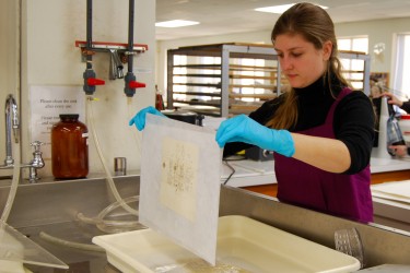 Conservator lifts document from bath