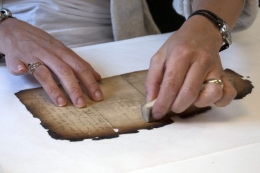 Surface cleaning a burned document