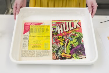 Paper Conservator Chloe Houseman displays a rare copy of The Incredible Hulk #181 before 