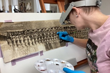 Ivy working on a WWI-era panoramic photo, from the collection of a local client, depicting the School of Aeronautics of the Royal Air Force and the Royal Flying Corps in Canada. 