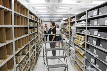 Storage space, with people standing around and a ladder in the center.