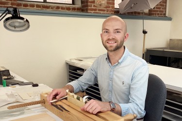 CCAHA Summer 2025 Intern, Luke Kelly. He is sitting at a desk and wearing a blue shirt.